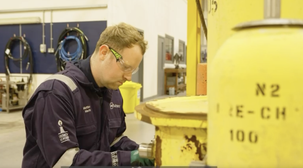 Engineer working on subsea control system equipment during maintenance and refurbishment